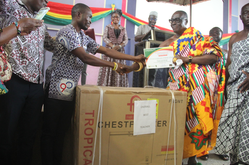 Mr. Atta Kyeremeh receiving the overall best teacher award from the Asemhene