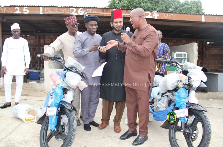 Maulvi Abdul Hameed (2nd from right) receiving the motorbike keys from the Mayor 