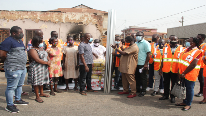 Mr. Agyemang Prempeh presenting the items to the victims of the fire outbreak