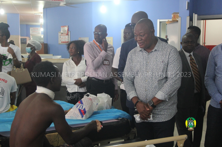 Hon. Sam Pyne interacting with an accident victim at the Accident and Emergency Unit of KATH